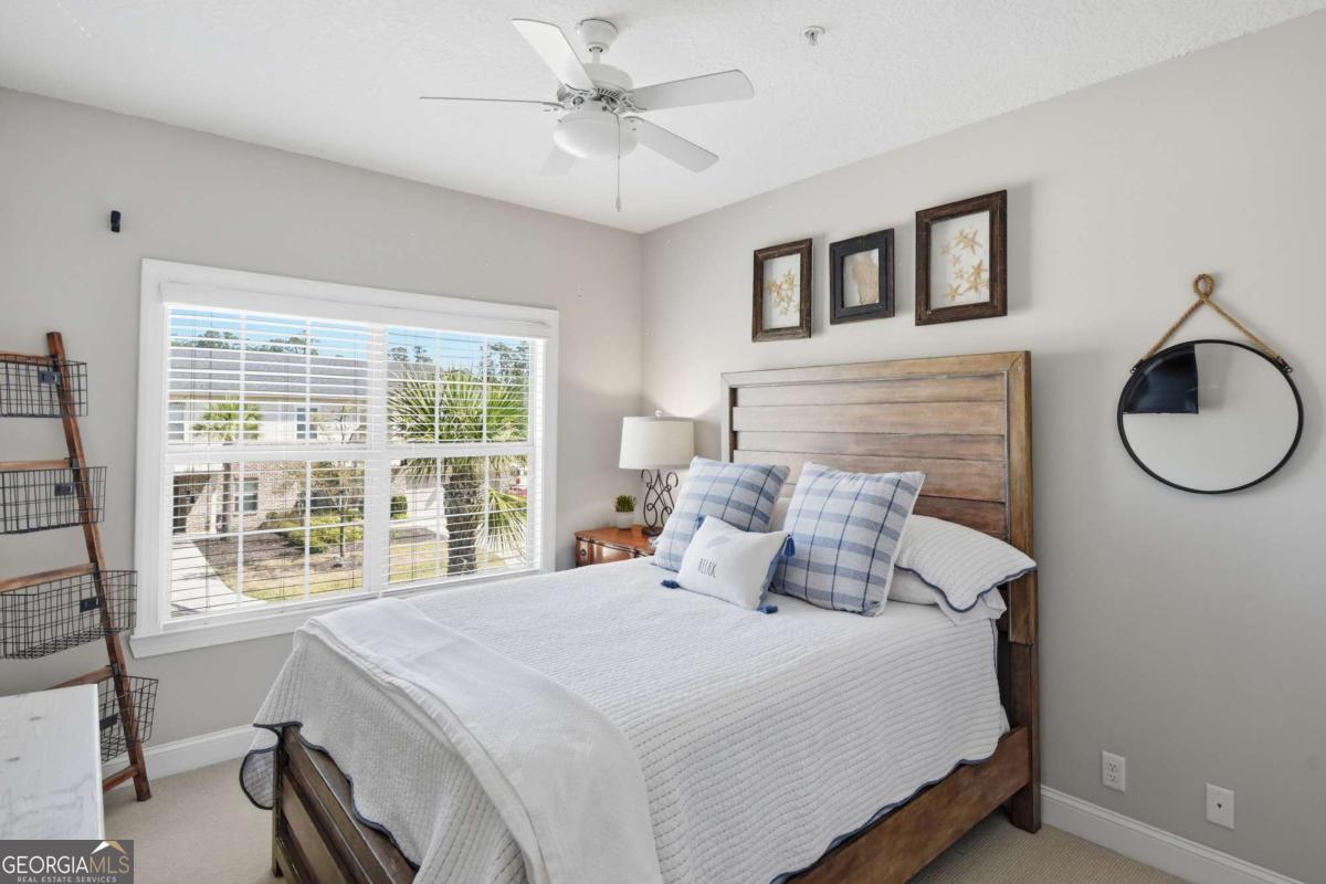 203 Mariners Circle St. Simons, GA 31522 - Photo 31 of 32 a bedroom with a large bed and a window