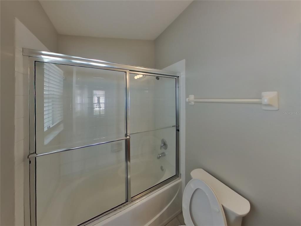 Undisclosed Address Land O Lakes, FL 34639 - Photo 10 of 15 a bathroom with a granite countertop toilet and a shower