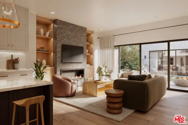 a living room with fireplace furniture and a large window
