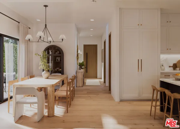 a dining room with wooden floor a chandelier a wooden table and chairs