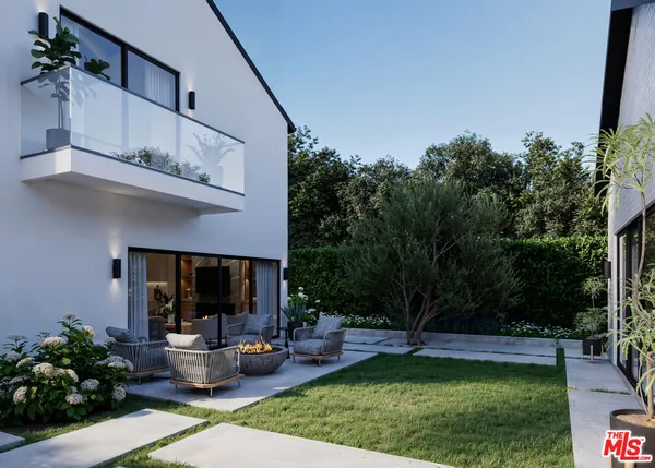 a view of a backyard with sitting area and garden