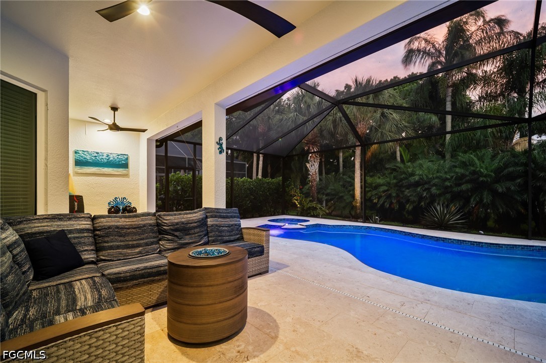 9042 Bronco Court Naples, FL 34113 - Photo 28 of 50 a living room with furniture and floor to ceiling window