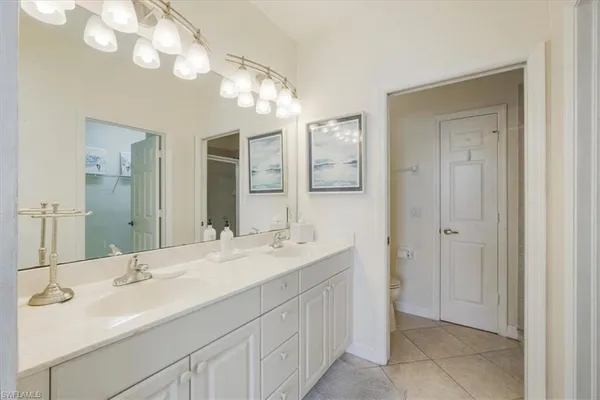 a bathroom with a sink vanity and a mirror