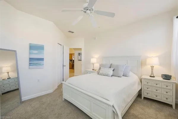 a bedroom with a bed and a night stand