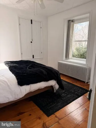 a view of a closet with wooden floor and a book shelf