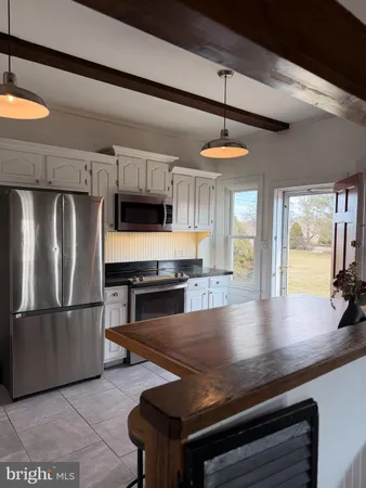 a kitchen with white cabinets