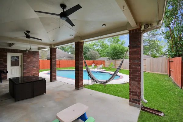 a view of a porch with furniture and a backyard