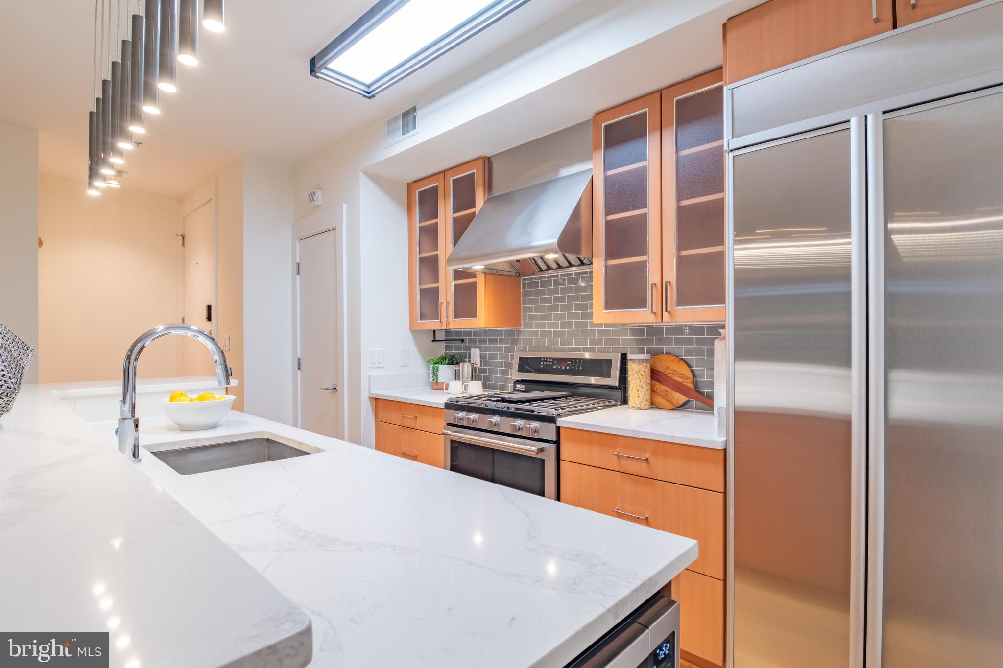 1735 Johnson Avenue Northwest, Unit B Washington, DC 20009 - Photo 13 of 34 a kitchen with stainless steel appliances a stove a sink and a refrigerator