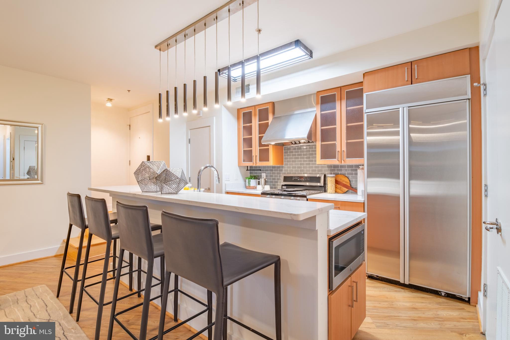 1735 Johnson Avenue Northwest, Unit B Washington, DC 20009 - Photo 14 of 34 a kitchen with stainless steel appliances a sink stove and a refrigerator