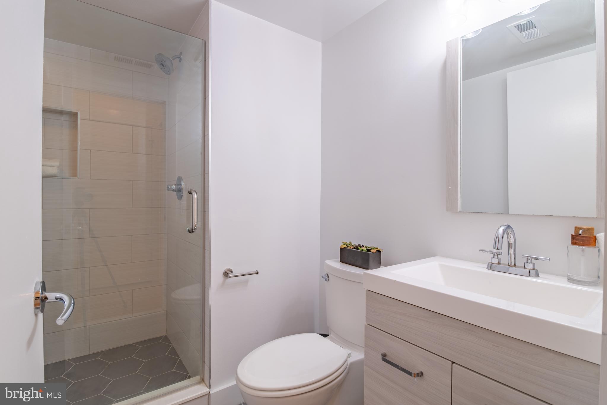 1735 Johnson Avenue Northwest, Unit B Washington, DC 20009 - Photo 17 of 34 a bathroom with a sink a toilet and shower