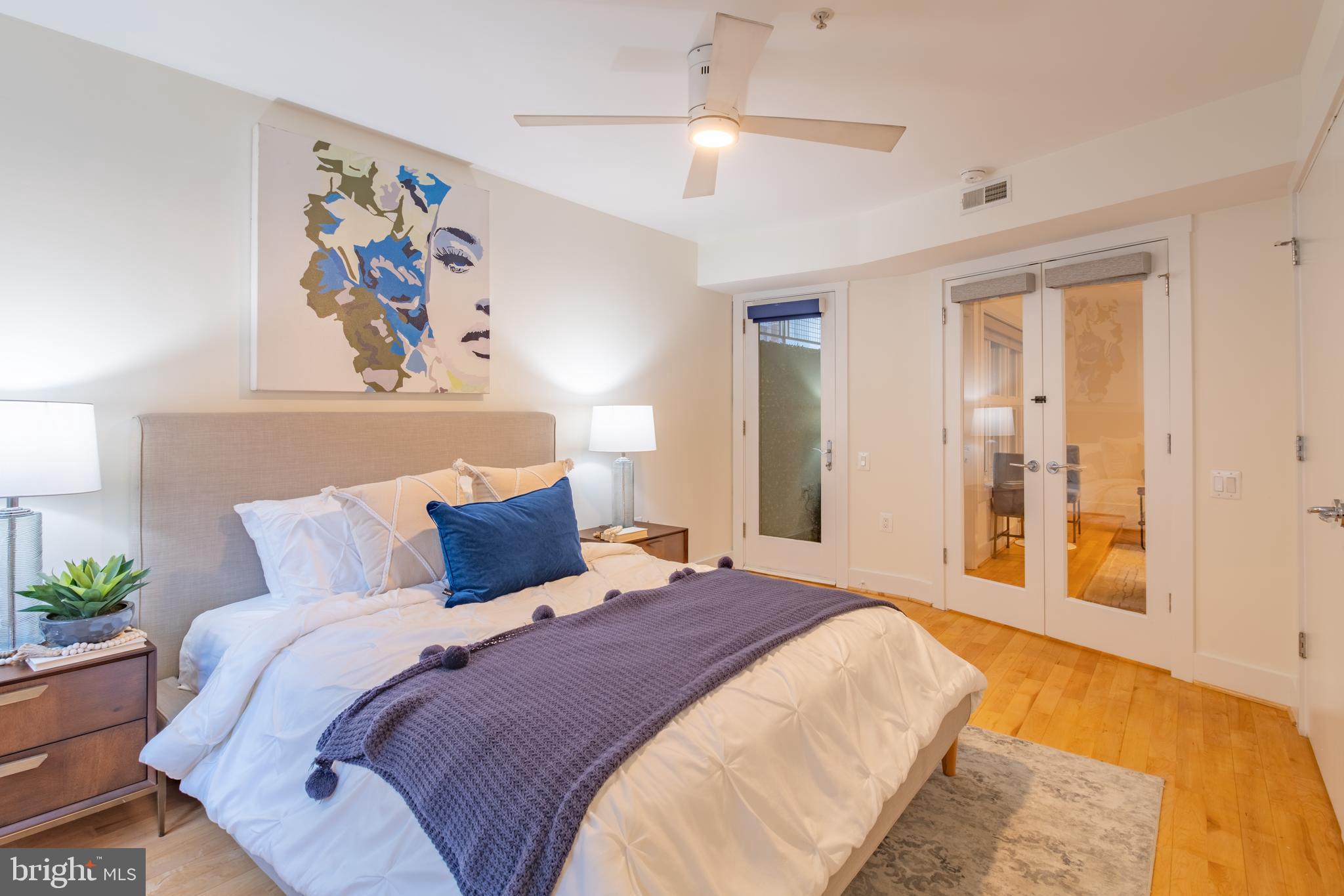 1735 Johnson Avenue Northwest, Unit B Washington, DC 20009 - Photo 29 of 34 a bedroom with a large bed and a chandelier