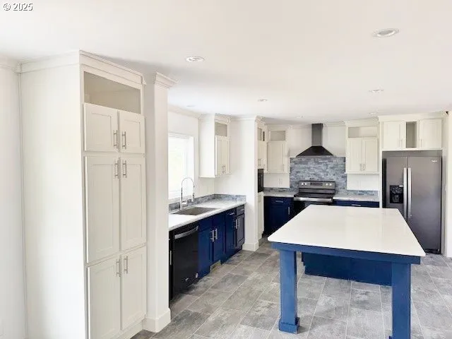 a kitchen with refrigerator and cabinets