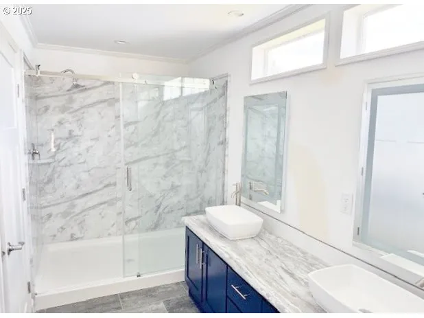 a bathroom with a granite countertop sink and mirror with bathtub