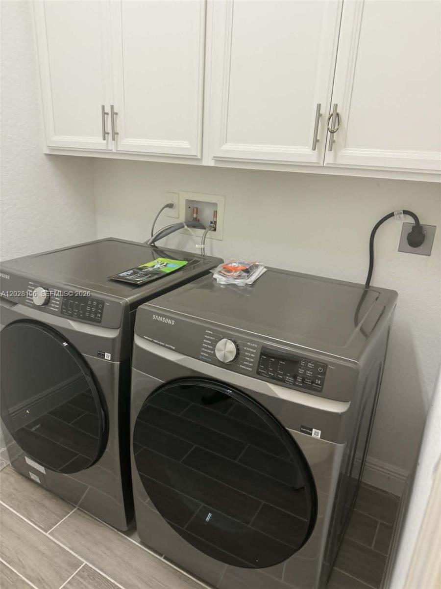 4710 Southwest Ardsley Drive Stuart, FL 34997 - Photo 3 of 7 a utility room with dryer and washer