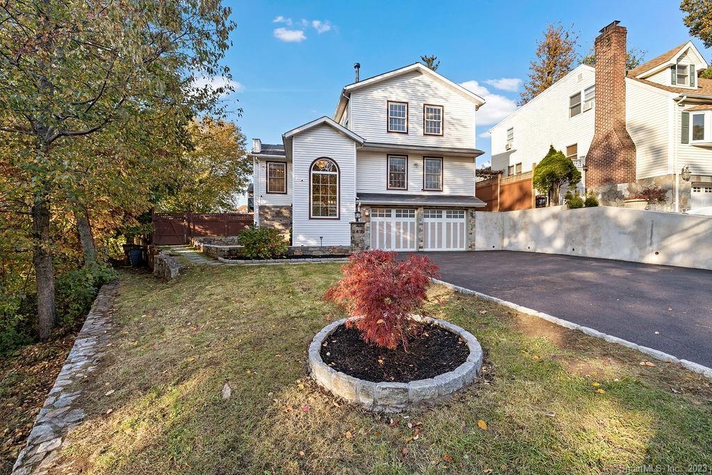 47 Uncas Road Stamford, CT 06902 - Photo 1 of 1 a view of a white house with a yard and potted plants