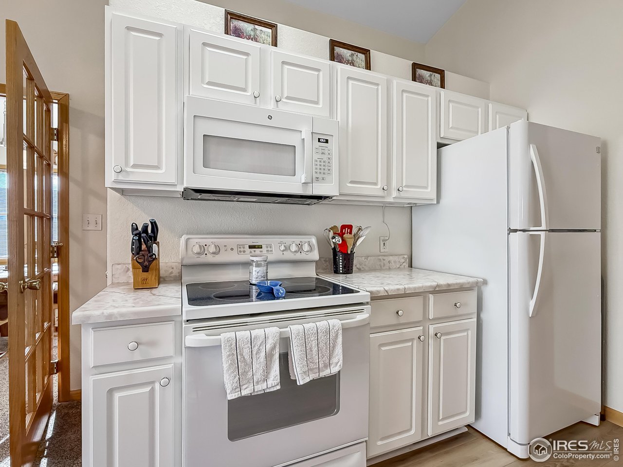 817 Mindy Circle, Unit B Sterling, CO 80751 - Photo 12 of 34 a kitchen with stainless steel appliances white cabinets and a refrigerator