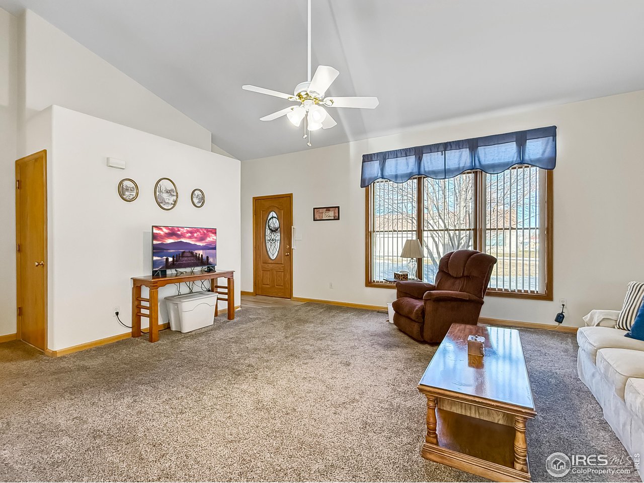 817 Mindy Circle, Unit B Sterling, CO 80751 - Photo 3 of 34 a living room with furniture and a flat screen tv