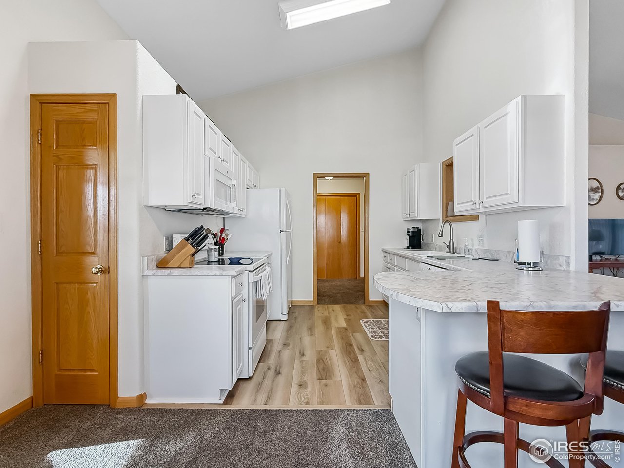 817 Mindy Circle, Unit B Sterling, CO 80751 - Photo 9 of 34 a kitchen with granite countertop cabinets and refrigerator