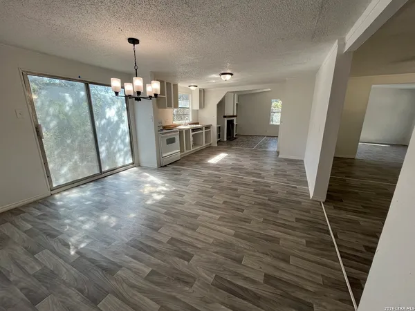 a view of a kitchen with furniture and an empty room
