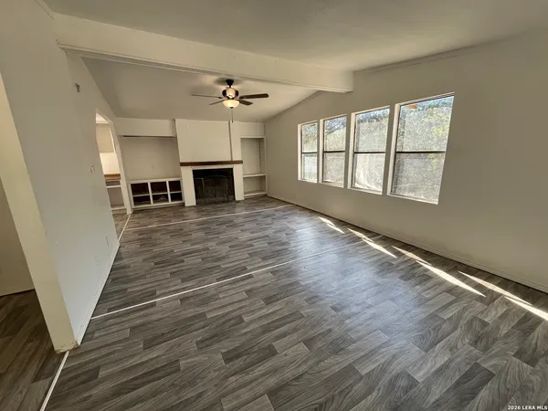 wooden floor in an empty room with a fireplace