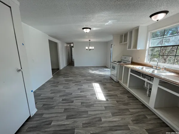 a large kitchen with stainless steel appliances granite countertop a stove and a sink