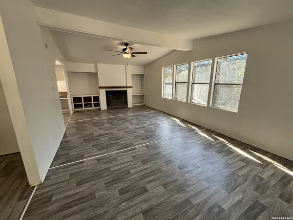 wooden floor in an empty room with a fireplace