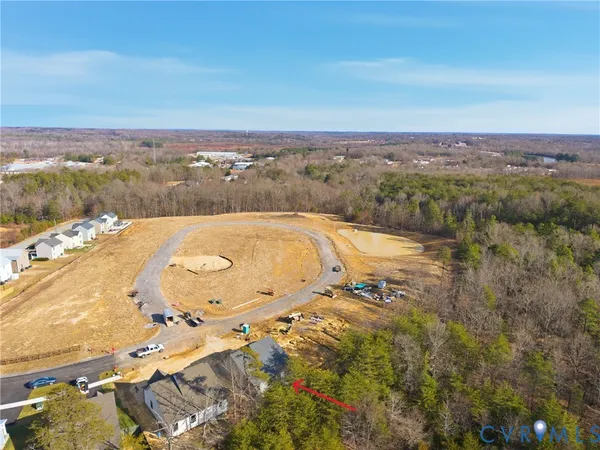 an aerial view of ocean with residential houses with outdoor space