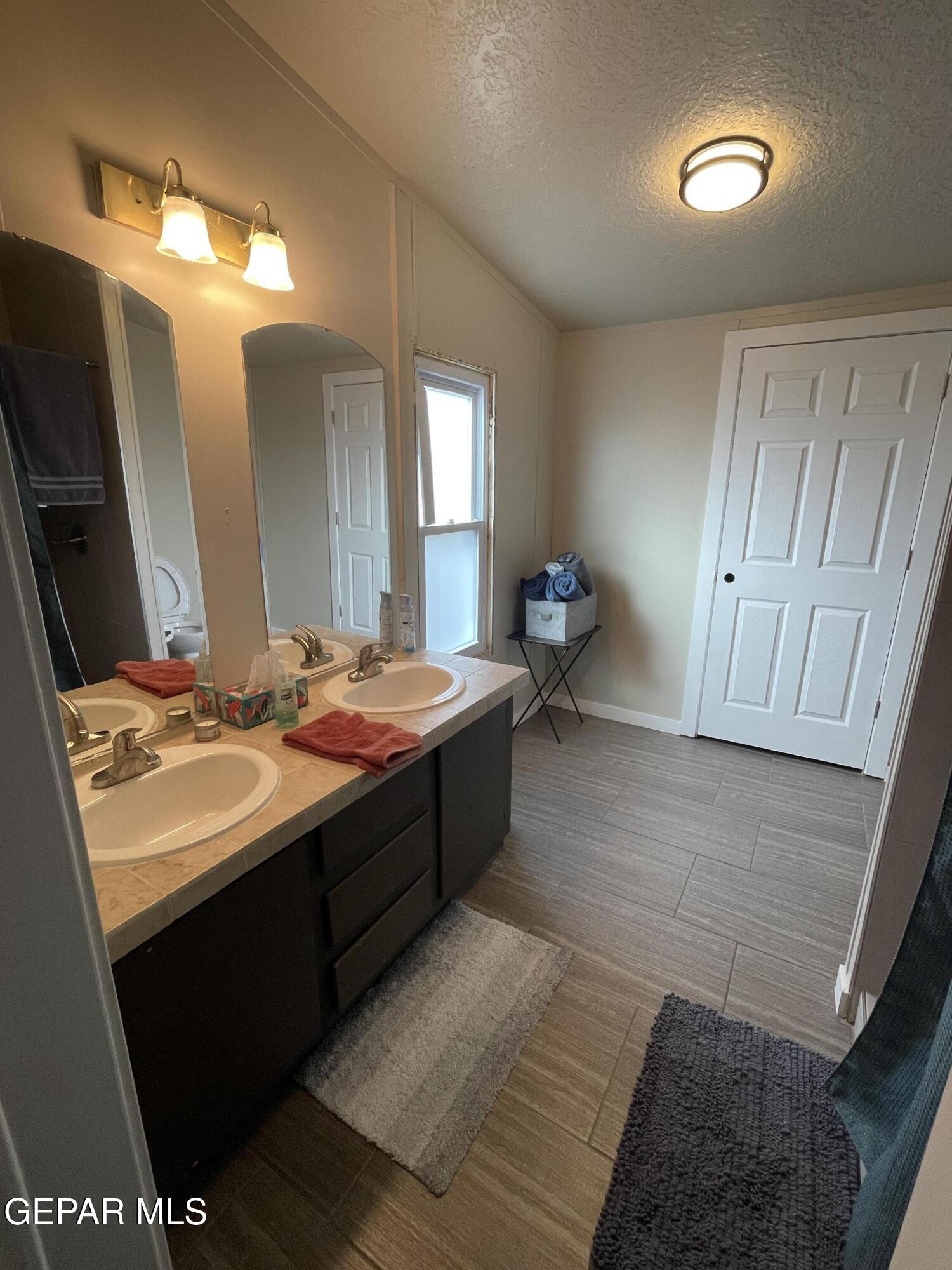 2901 Cook Street Truth Or Consequences, NM 87901 - Photo 12 of 28 a bathroom with a sink and a mirror