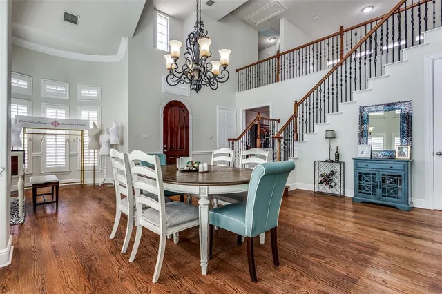 a view of a dining room with furniture wooden floor and chandelier
