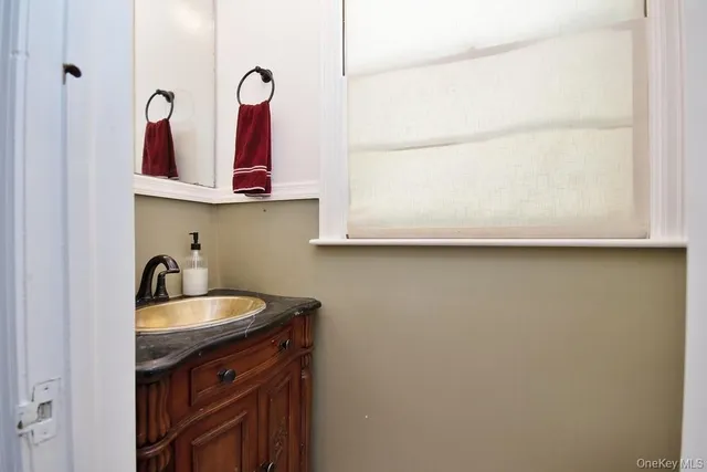 a kitchen with a sink and a mirror