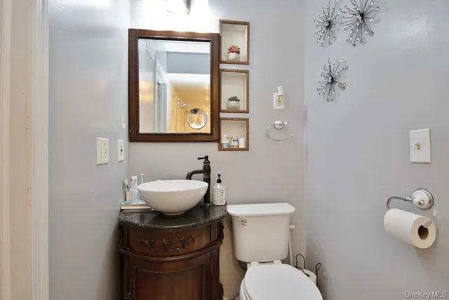a bathroom with a toilet sink and mirror
