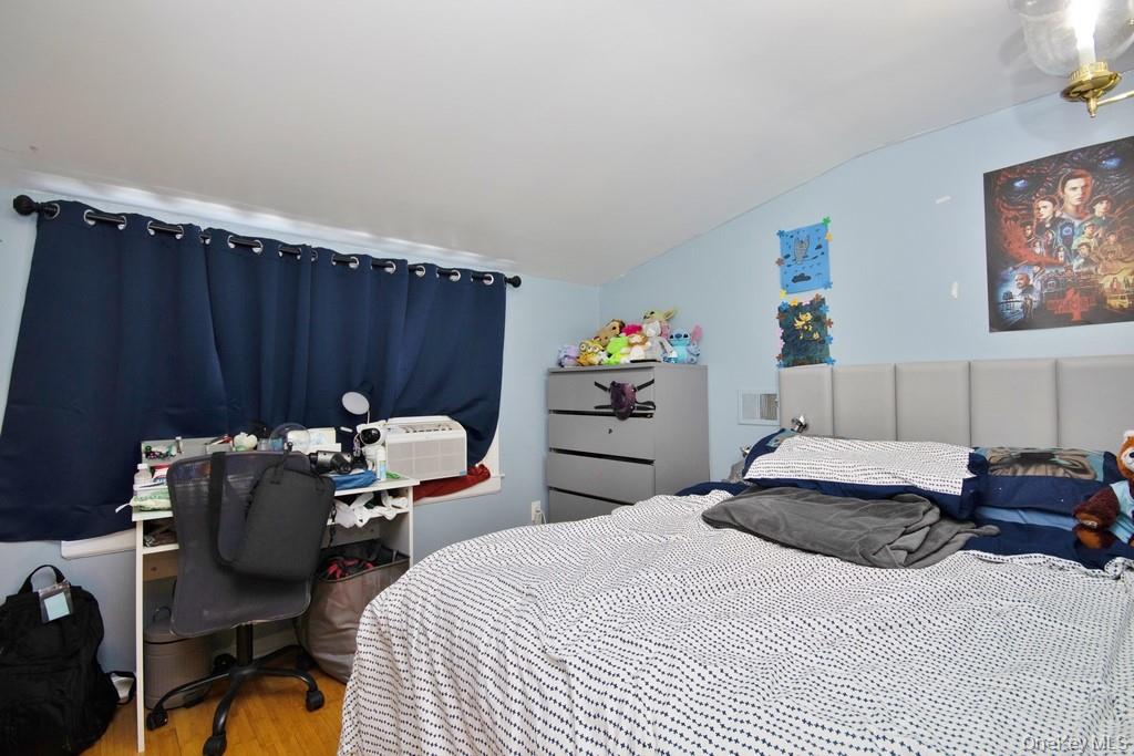 1 Noel Drive Ossining, NY 10562 - Photo 21 of 33 a bedroom with bed a chair and potted plant on the dresser