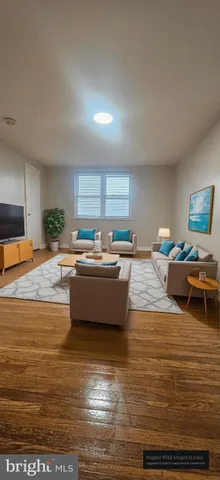 a living room with dining room and kitchen view