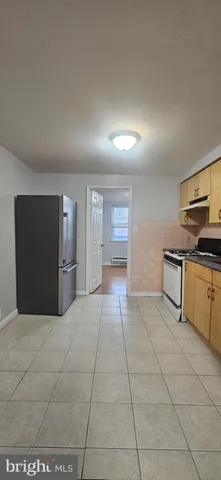 a kitchen with stainless steel appliances granite countertop a refrigerator and a stove