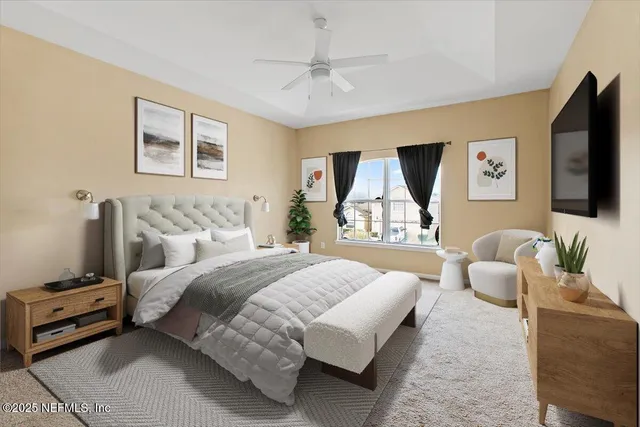 a bedroom with a bed couches and a flat tv screen