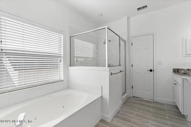 a bathroom with a bathtub and a shower