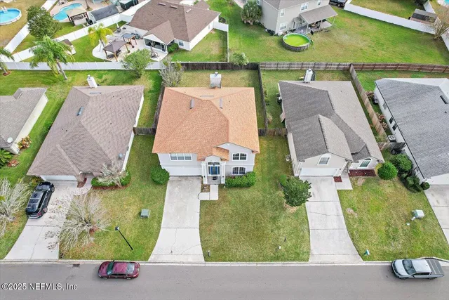 an aerial view of houses with outdoor space