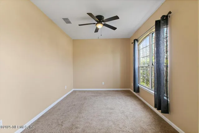 a view of room with window and ceiling fan