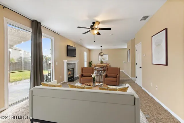 a living room with furniture fireplace and flat screen tv