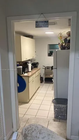 a kitchen with a sink a stove and cabinets