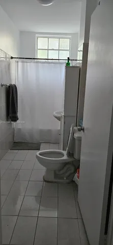 a bathroom with a toilet and a mirror