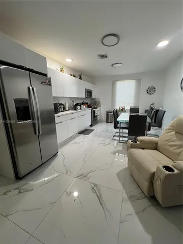 a living room with furniture and a counter top space
