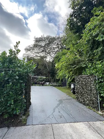 a view of a pathway both side of yard