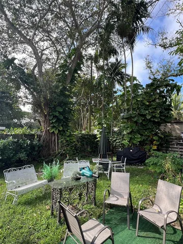 a view of backyard with seating area and green space