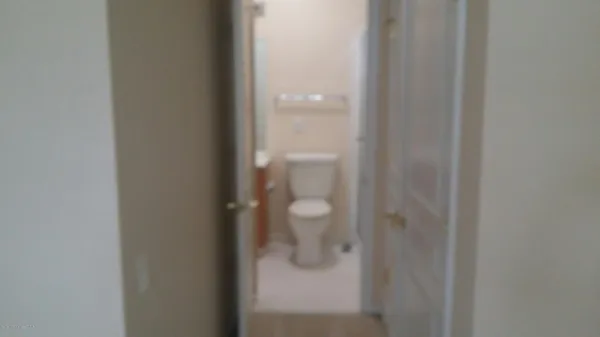 a white toilet sitting next to a bath tub