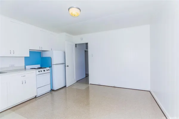 a kitchen with white cabinets and white appliances