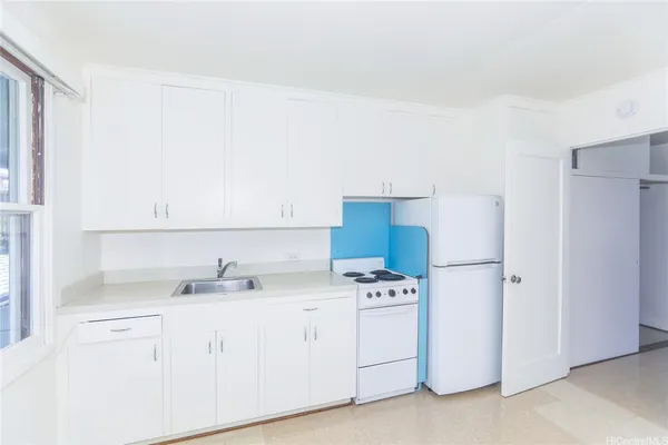 a kitchen with cabinets and white appliances