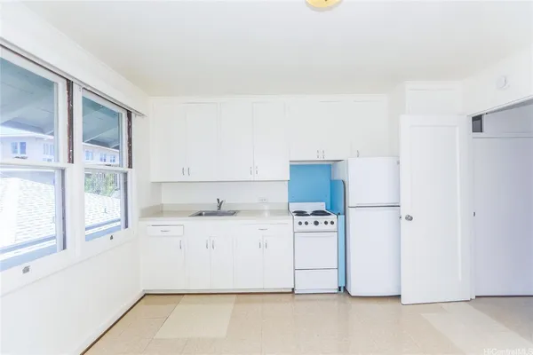 a kitchen with stainless steel appliances a refrigerator a stove a microwave a sink and cabinets