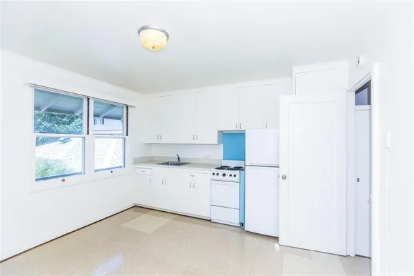 a kitchen with stainless steel appliances a refrigerator and a stove