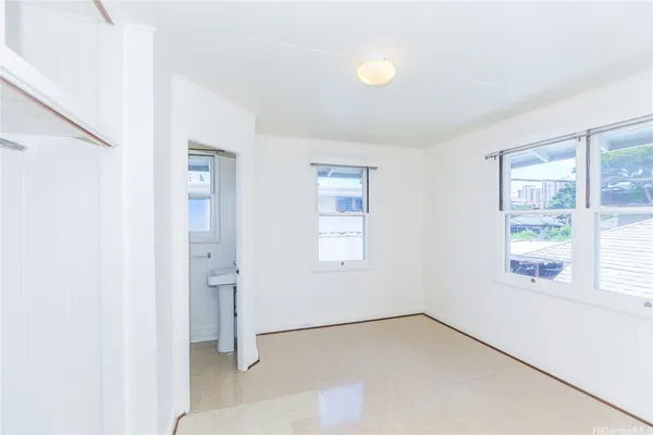 an empty room with windows and closet